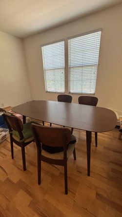 6-person dining table with 4 chairs with a floor lamp