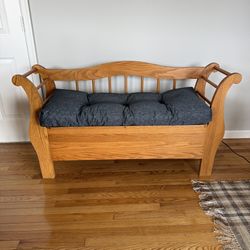 Wooden slat back storage seating bench with gray cushion