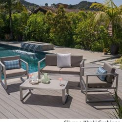 Outdoor patio couch with chairs and coffee table