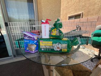 Guinea pig cage with food and hay and water dispenser