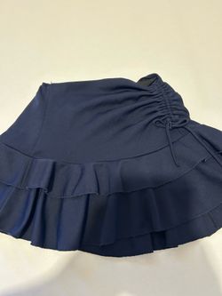Navy blue school skort with ruffles and side drawstring, girls' size 11/12.