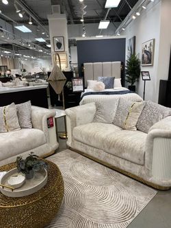 Sophisticated designed cream upholstered sofa with gold stainless steel diamond accents