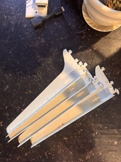 white metal shelf brackets