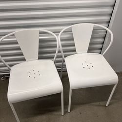 Two White Metal Chairs
