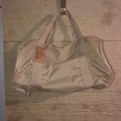 Vintage Jordache small tan duffel bag. It has a small rust spot & no shoulder strap. See pics for details and dimensions