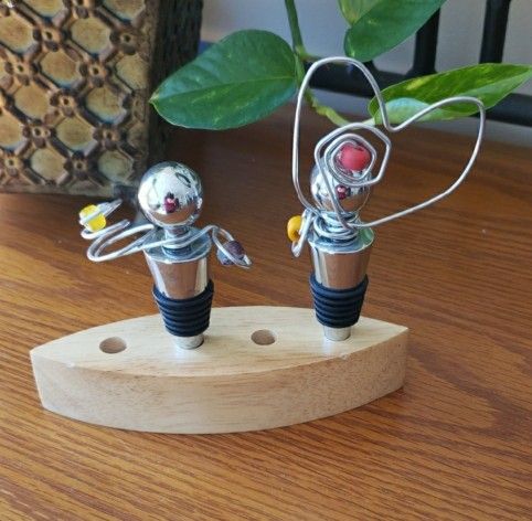 2 Silver Wine Bottle Stoppers with Heart Design & Stand