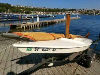 1978 Sailboat. 10' Mini Fish single hull Sunfish style and same manufacturer, Alcort. Hawke Boat Trailer is fully adjustable. $600