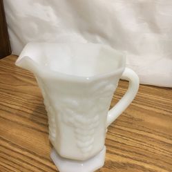 Vtg Milk Glass Footed Paneled 6 3/4 “ tall pitcher w/grape vine pattern