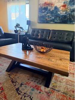 Ashley Furniture Wesling coffee table with a light brown distressed wood top and black metal base.