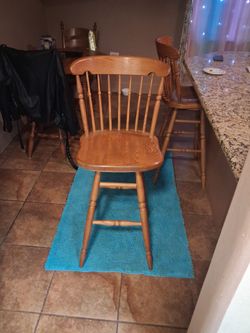 Two swivel tall vintage solid oak stools