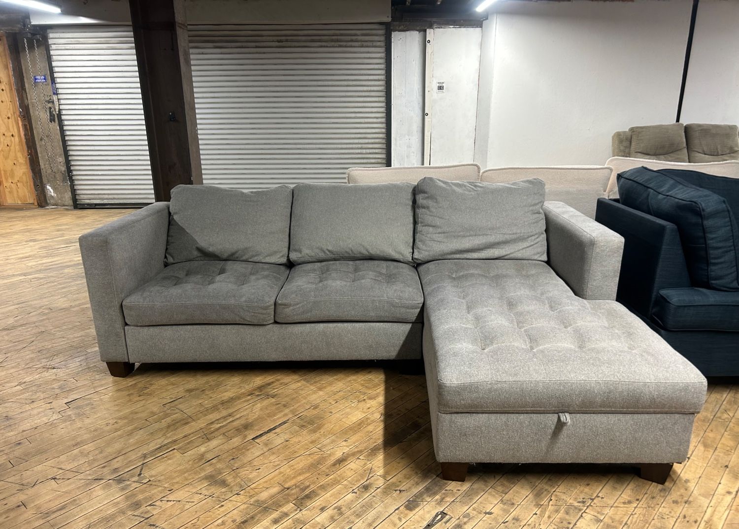 Delivery available gray sectional couch and storage