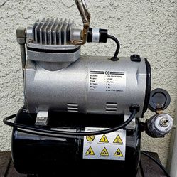 TC-20T airbrush compressor, a single-cylinder mini air compressor often used for hobbies and fine art. 
It features an automatic stop function and a 3