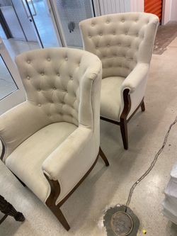 cream linen tufted wingback accent chairs with exposed wood trim