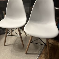 Two White Molded Chairs