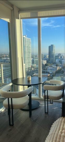Round Black Dining table and two barrel chairs