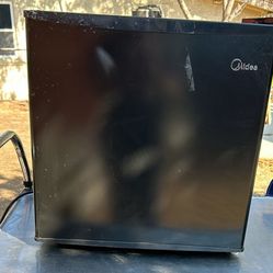 Mini  Refrigerator ( This Is The Short On Sitting On A Table