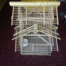 Bird cage made out wood.