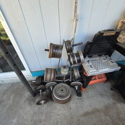 Old Iron Weights With Bar Bells And Dumb Bells With Rack