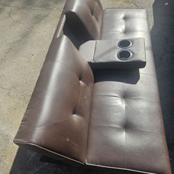 Adjustable leather futon with metal legs comparable to a twin matress