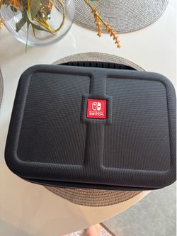 Brand New Nintendo Switch Travel Case Never used. Large hard-shell carrying case for Nintendo Switch and accessories. Perfect condition.