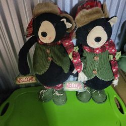 2  stuffed bears with seasonal outfits and " Welcome" signs