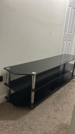 Black glass TV stand holds up to “75