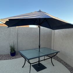 Glass rectangle patio dining table with umbrella and stand