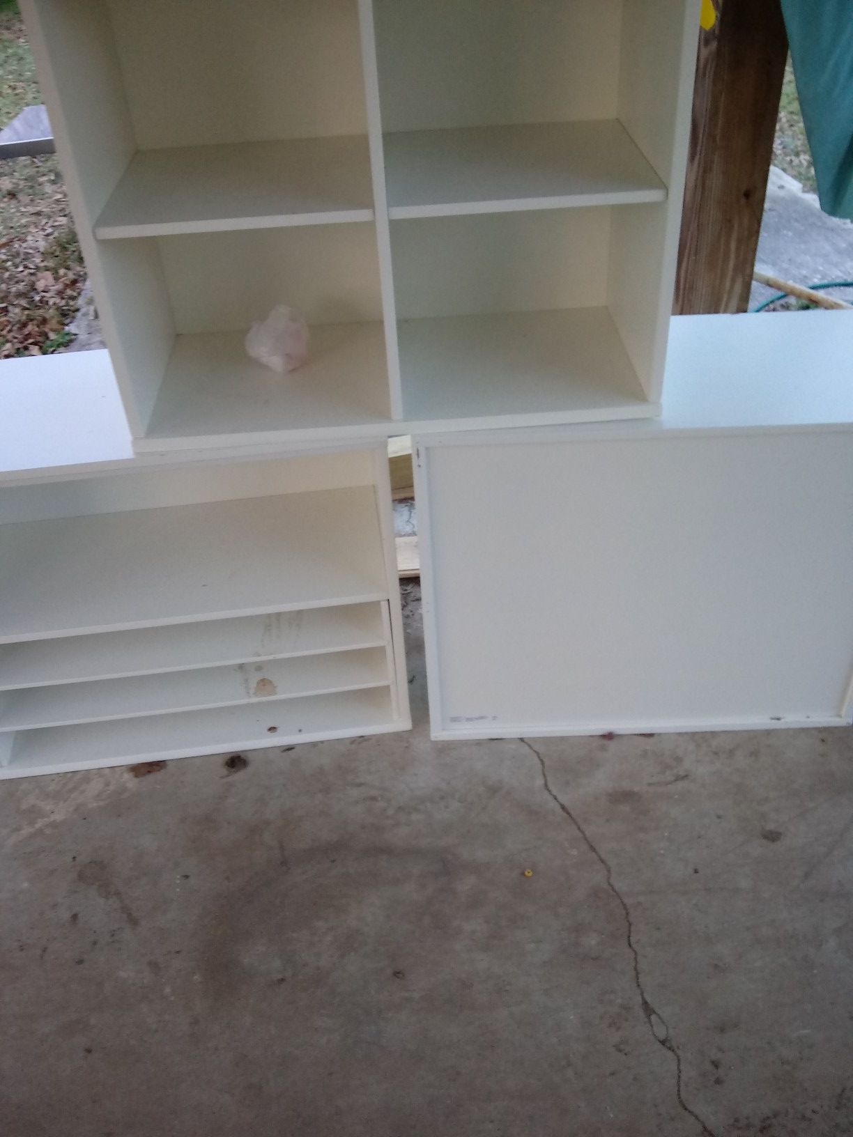 3 white storage shelves.