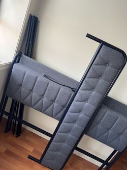 Grey queen size bed frame with charging ports on headboard