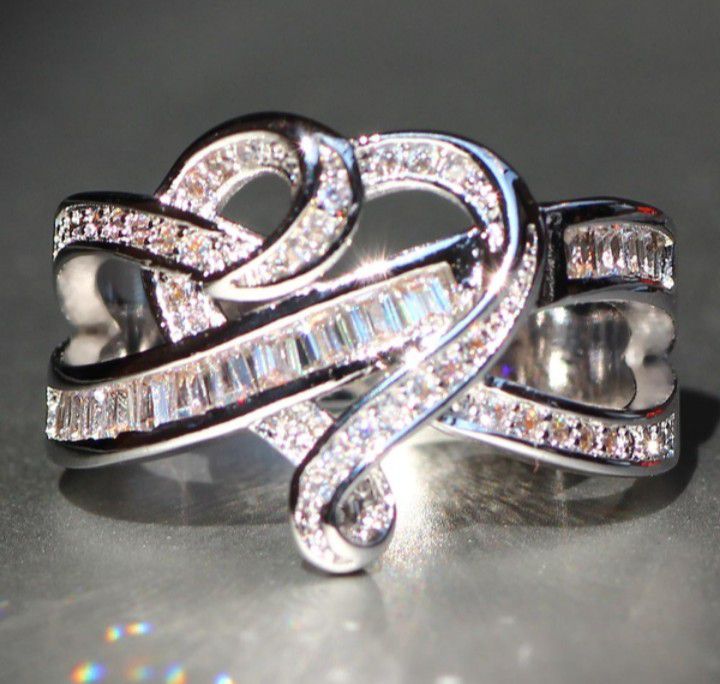 Sterling silver heart shaped ring with diamond baguettes. Stamped S925. Size 8