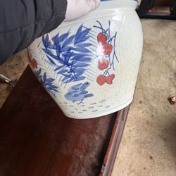 decorative Chinese porcelain fishbowl or planter pot, often used to display lucky goldfish or plants. 