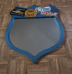 Mirror shaped like a shield