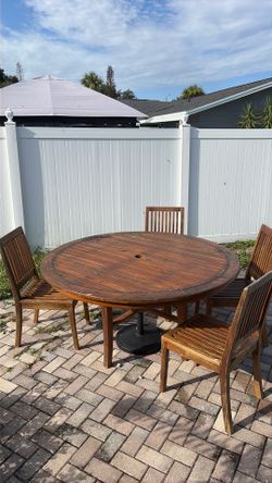 5 ft wood (teak) table and 5 chairs (has water damage)
