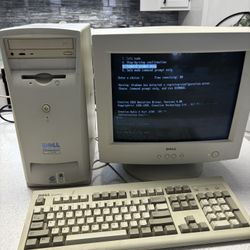 Vintage Dell computer monitor and keyboard and paperwork