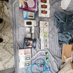 Assortment Of Electronics. Ear Buds, Chargers, Screen Protectors, Headphones