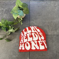 Red and white All We Need Is Money beanie
