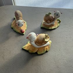 set of three vintage Homco ceramic snail figurines on leaves