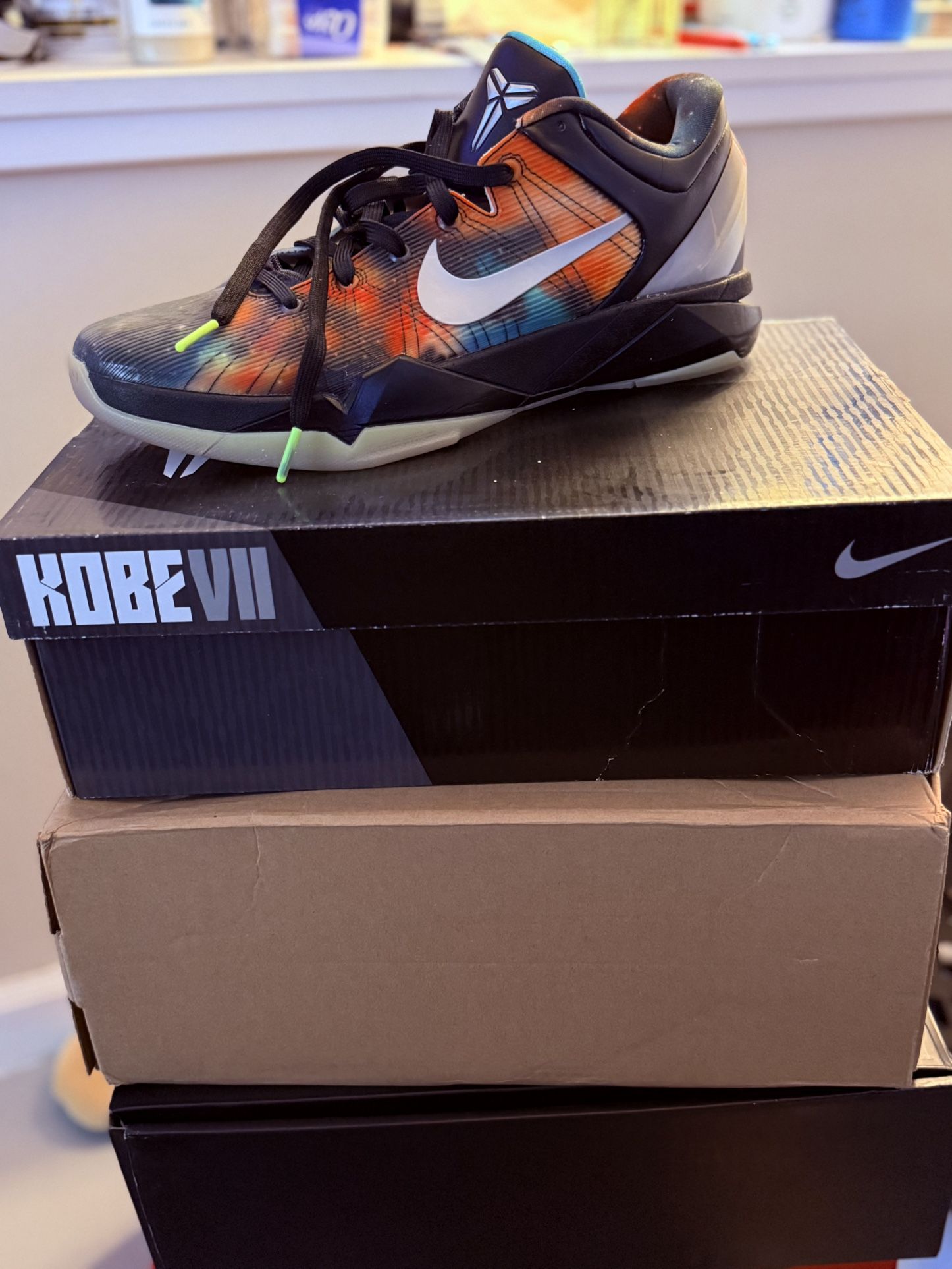 Nike Zoom Kobe 7 'All Star - Galaxy' sneaker in black, metallic silver, total orange, and volt colors