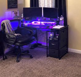 Black L-Shaped Gaming Desk with LED Lights and Chair