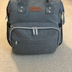 Gray Diaper Backpack With Foldout Bassinet. 