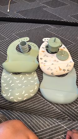Baby bibs, sippy cup with alternative cover for snacks, and baby cup