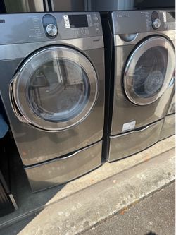 Samsung washer and electric dryer on pedestals