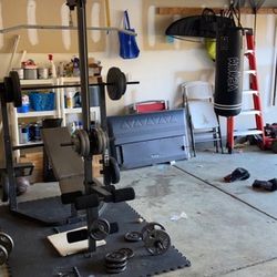Weights, Older Bench with mats, Punching Bag Included w/ Gloves 