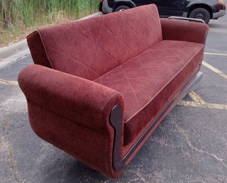 Red sofa with storage capacity.