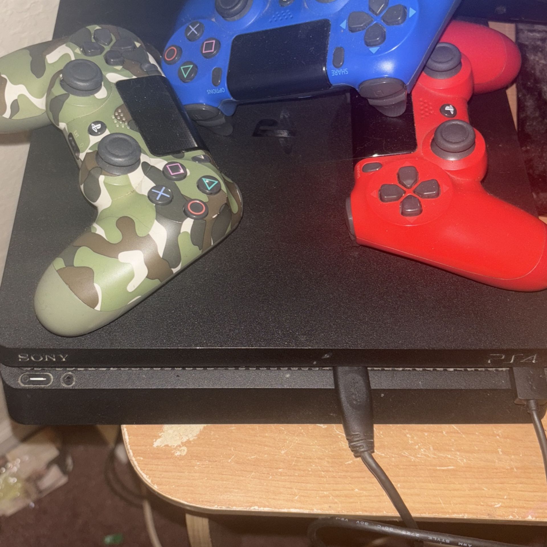 PS4 and PS3 duo with controllers