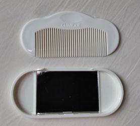 Vintage Clinique Comb and Mirror set. Snaps together, comb protects mirror, back has Clinique logo lettering. Lightweight, approximately 1.7 oz.