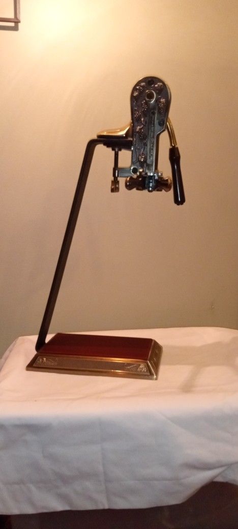 Vintners Reserve Brass Wine Bottle Opener Corkscrew Table Top Stand.
Measures 23 1/2" H
Base: 10 3/4" x 6 1/2"
Bronze finish.
Handle operates co