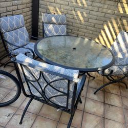 Patio set. Outdoor furniture. Table and four chairs. With cushions