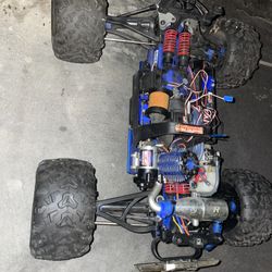 This is a Traxxas Revo 3.3 4WD Nitro Monster Truck.  It is powered by a TRX 3.3 nitro racing engine.  The truck can reach a top speed of 45 mph.  It f