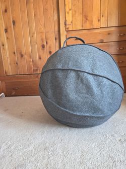 Grey exercise ball with fabric cover.  Easy to move and hold with the handle.